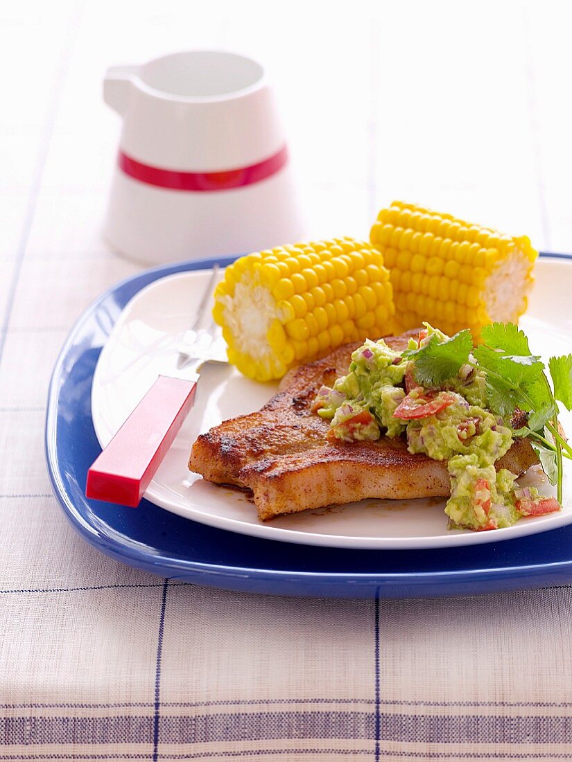Pork steak with guacamole and corn on the cob (Mexico)