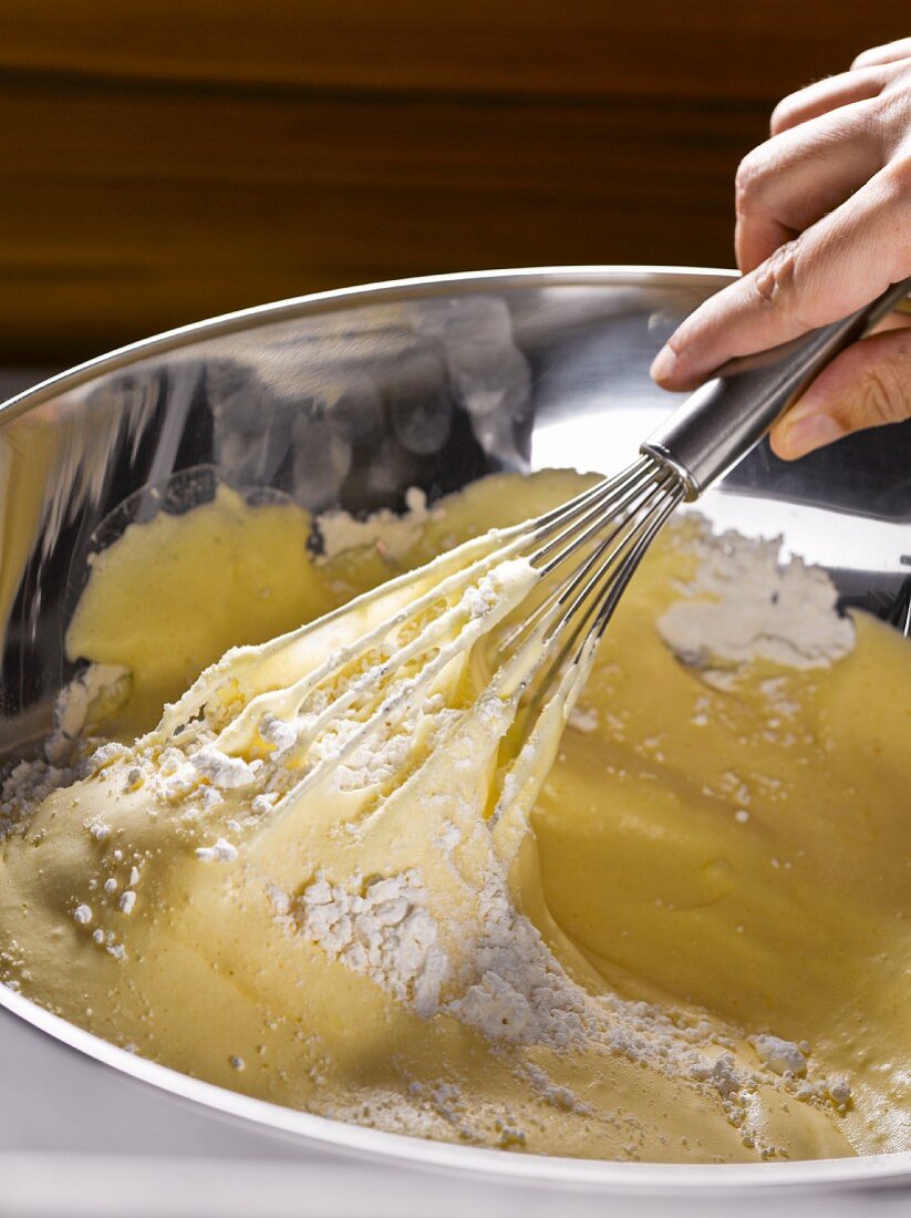 Preparing sponge mix: fold flour into egg mixture