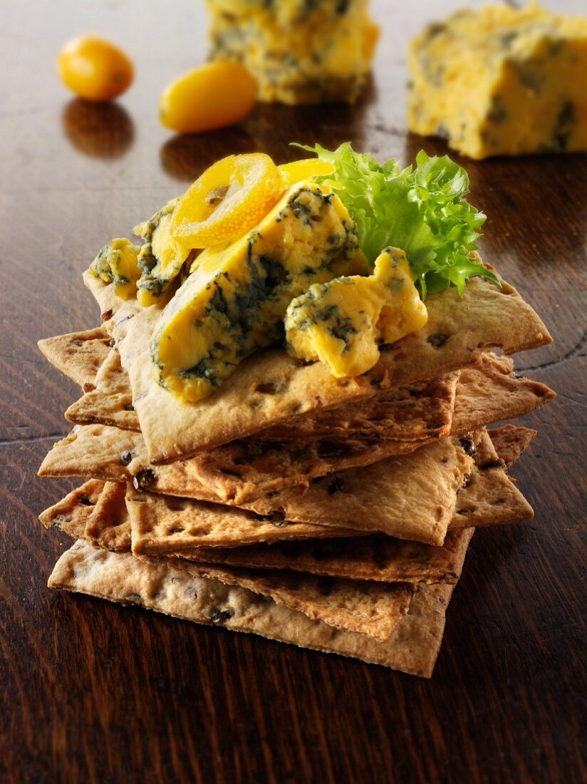 A stack of crackers with blue cheese