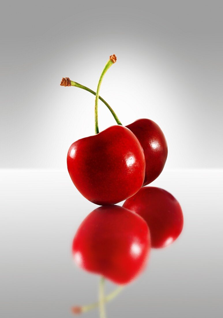 Two cherries on a glass plate