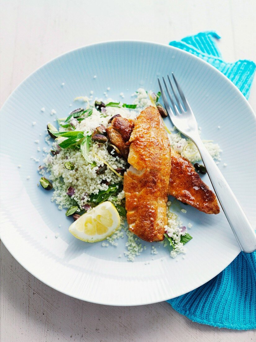 Fried fish fillets with lemon and pistachio couscous