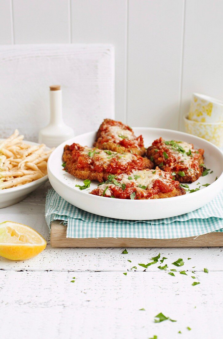 Veal escalope with tomatoes and parmesan cheese
