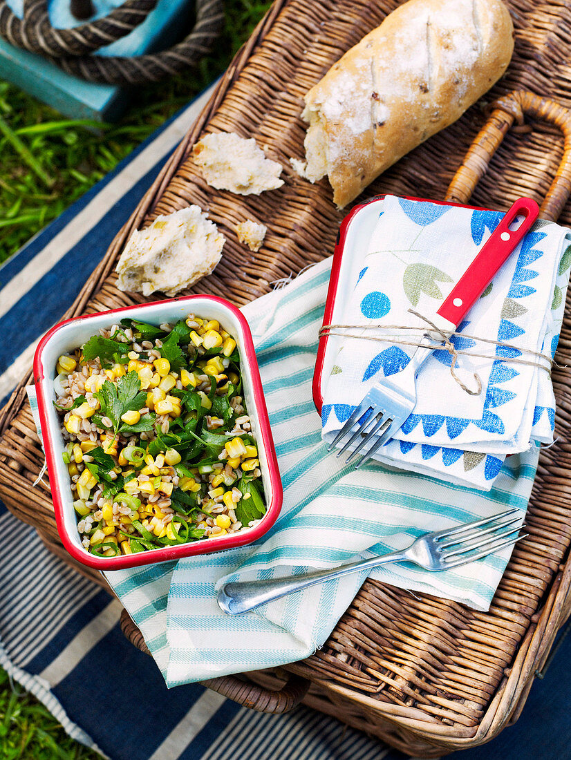 Farro sweetcorn salad and bread on a picnic basket