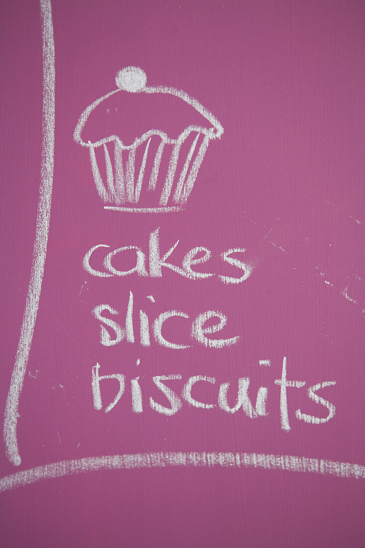 A sign advertising a cake sale