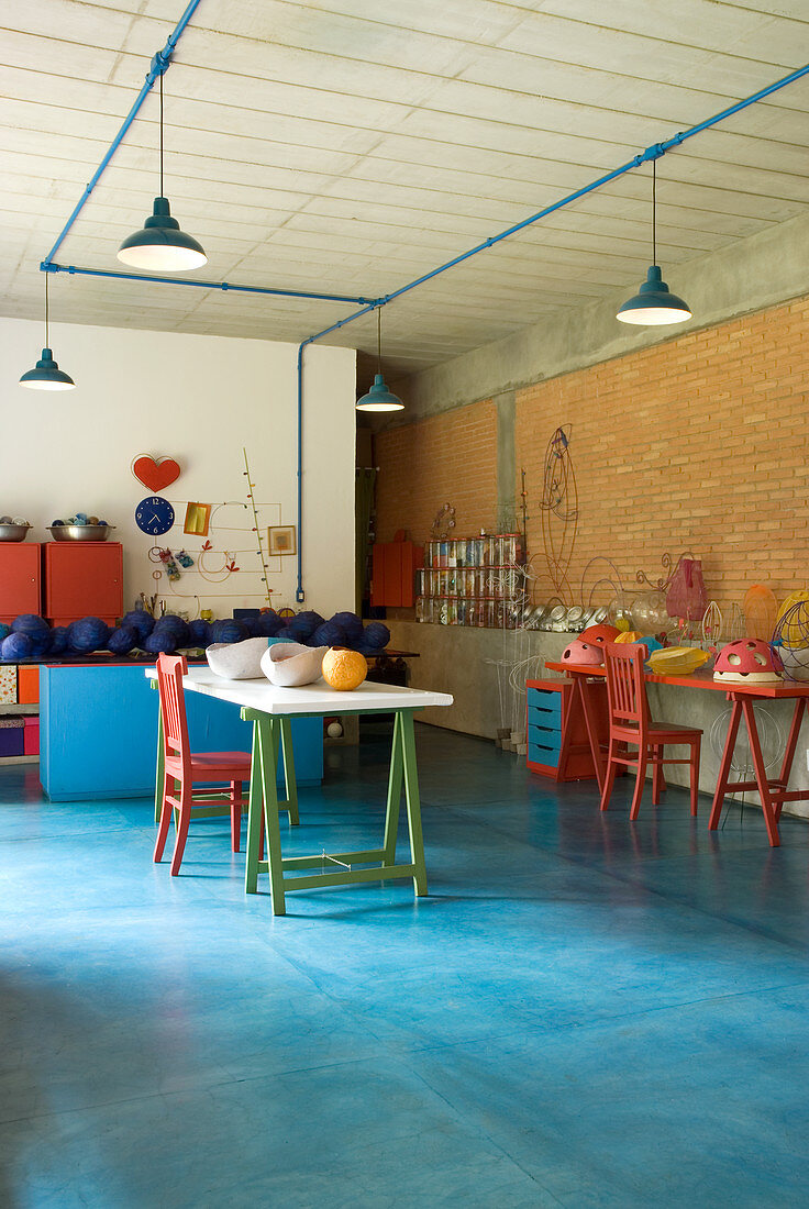 Half-finished designer objet on tables in artist's studio