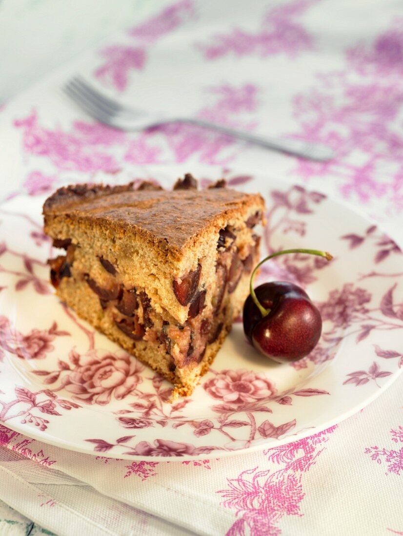 A slice of cherry cake with heart cherry