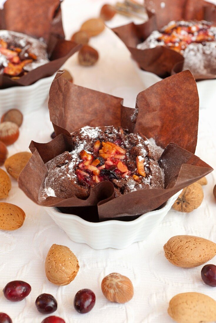 A mini chocolate cake with almonds, walnuts and cranberries