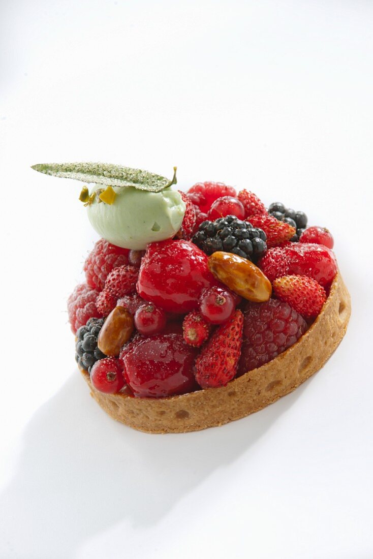 A berry tartlet with a pistachio and mascarpone dumpling