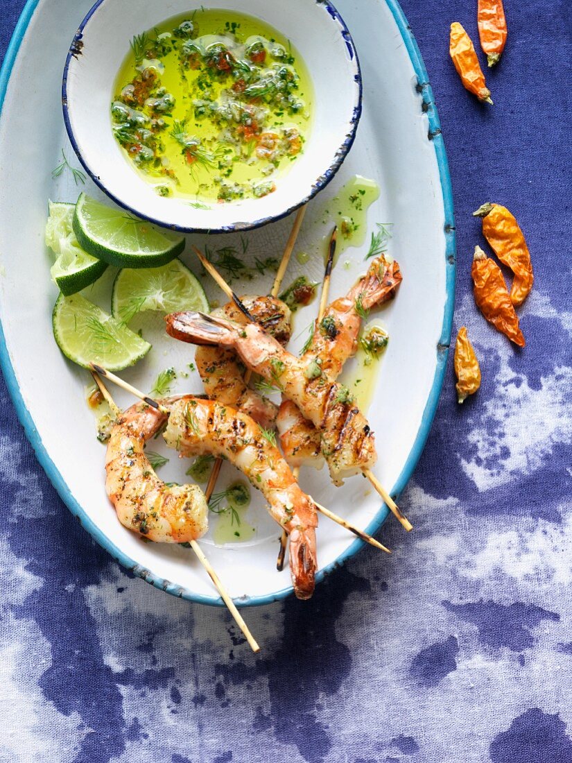 Platter of Grilled Skewered Shrimp with Herb Sauce and Limes
