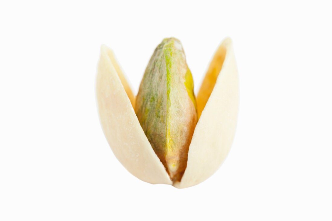 An opened, toasted pistachio against a white background