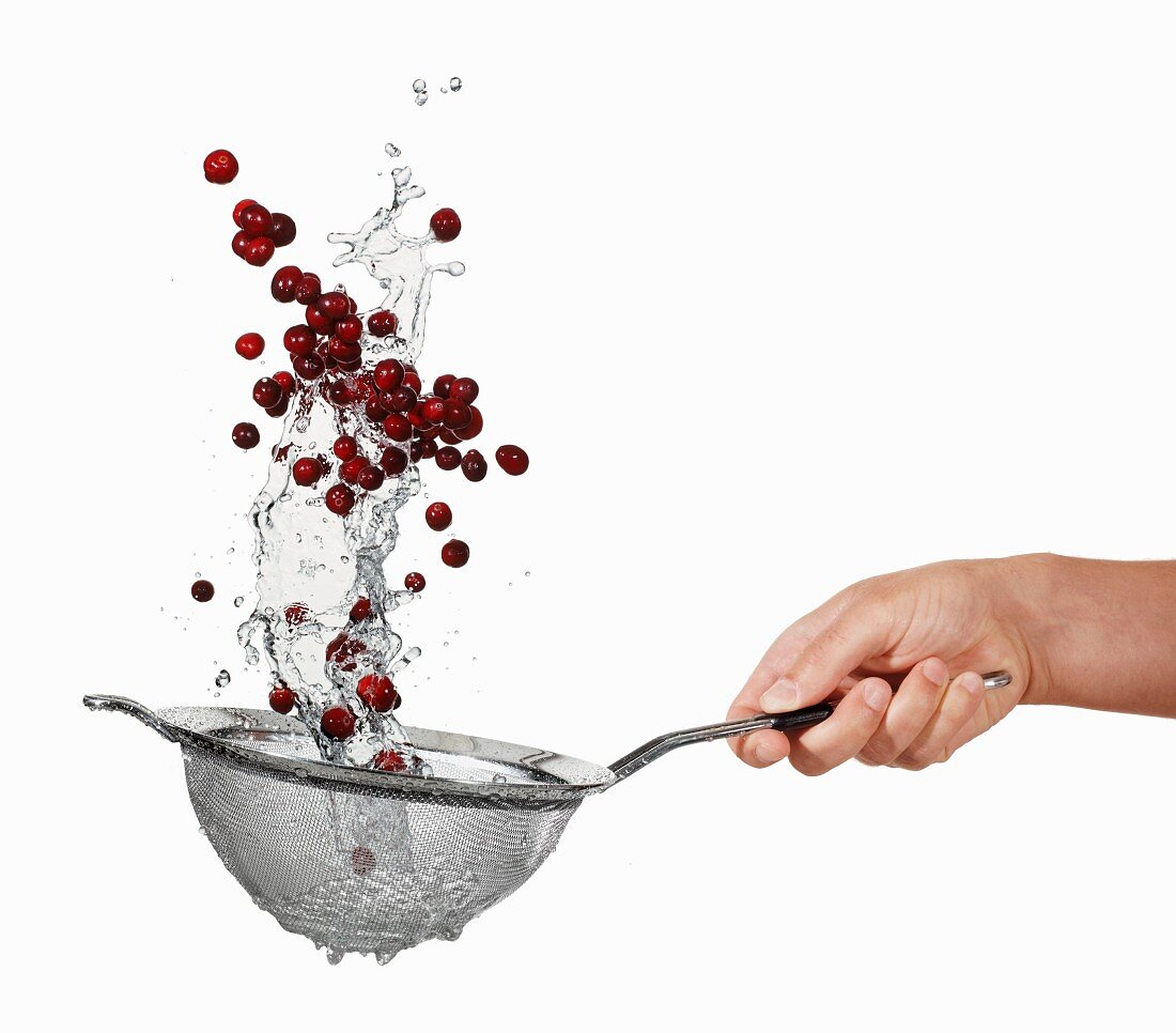 Washing cranberries in a sieve
