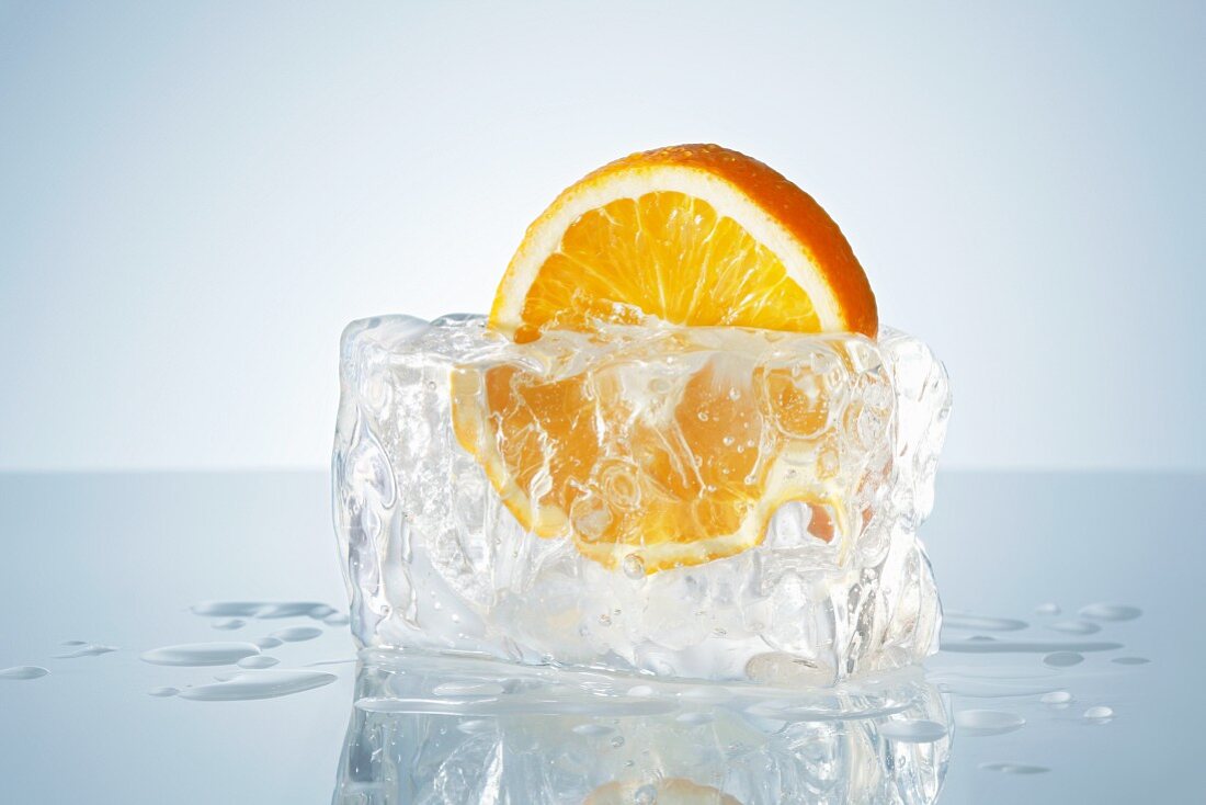 Half an orange in a block of ice