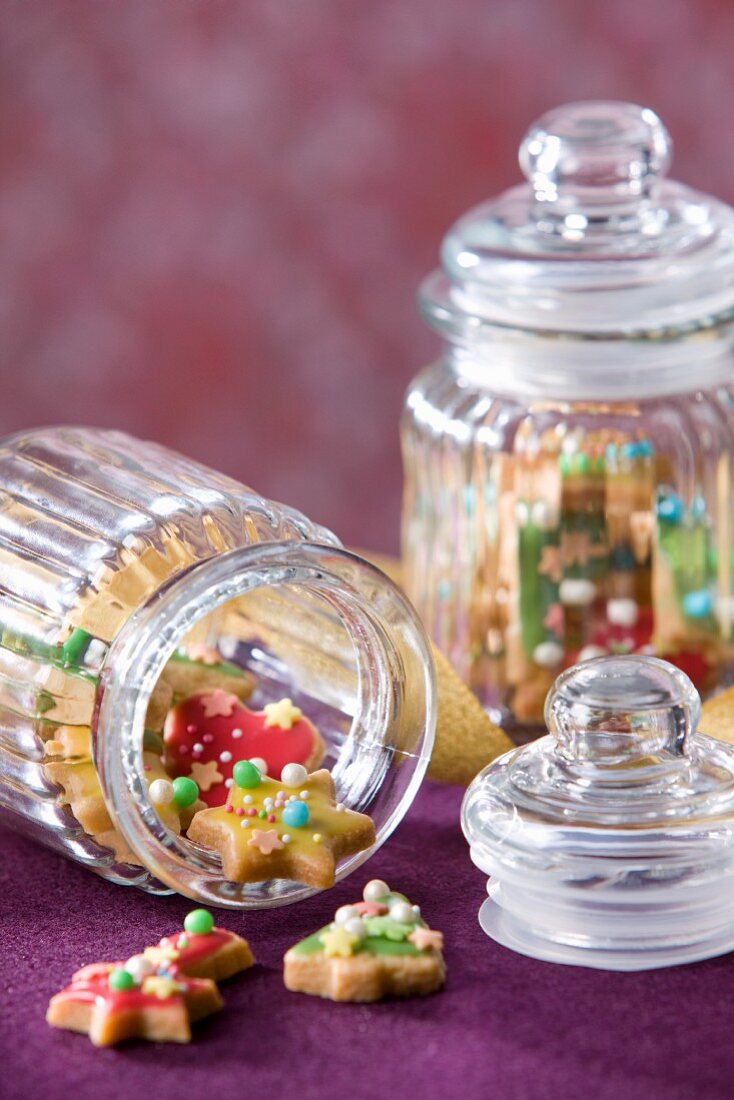 Colorfully decorated Christmas cookies in cookie jars