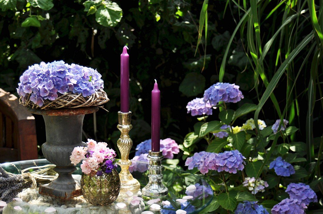 Summery table centre of hydrangeas and candlesticks