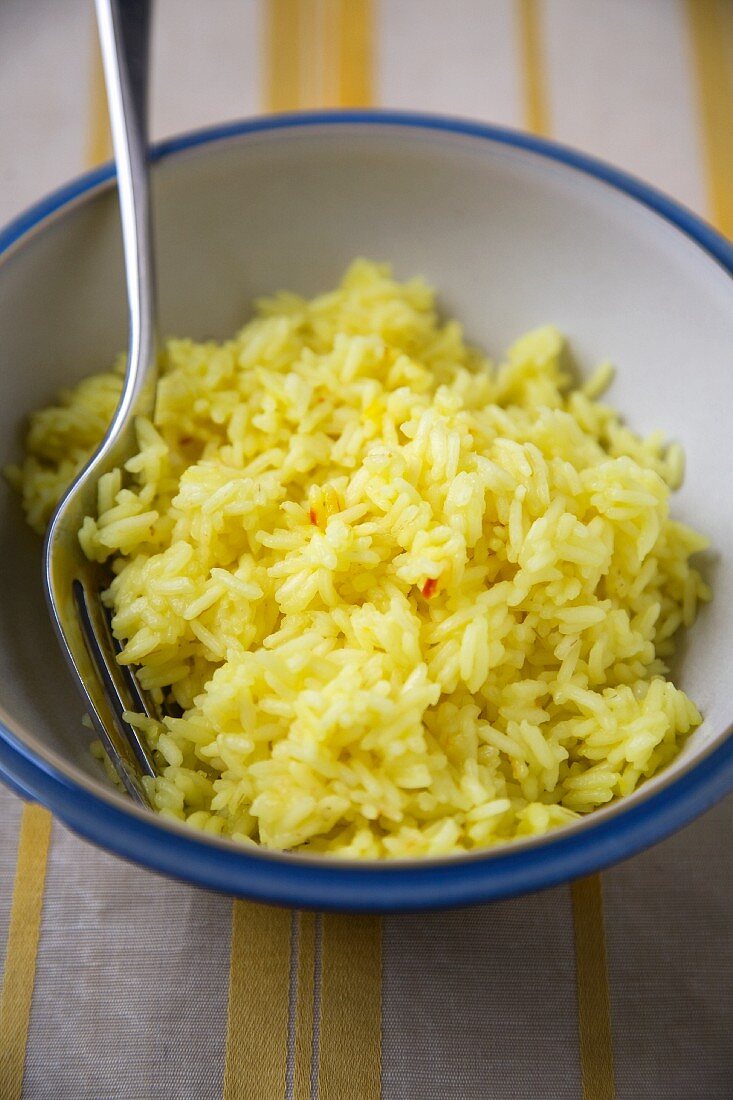 Bowl of Saffron Rice with a Fork