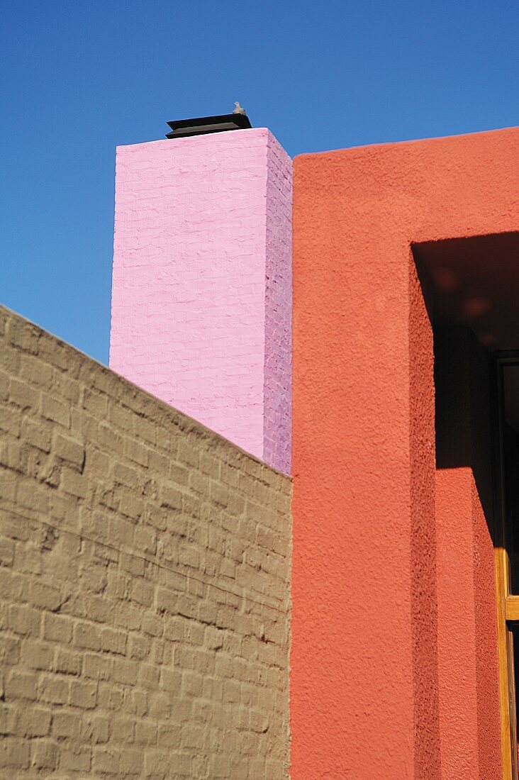 Violet and red plastered facades and grey whitewashed brick wall