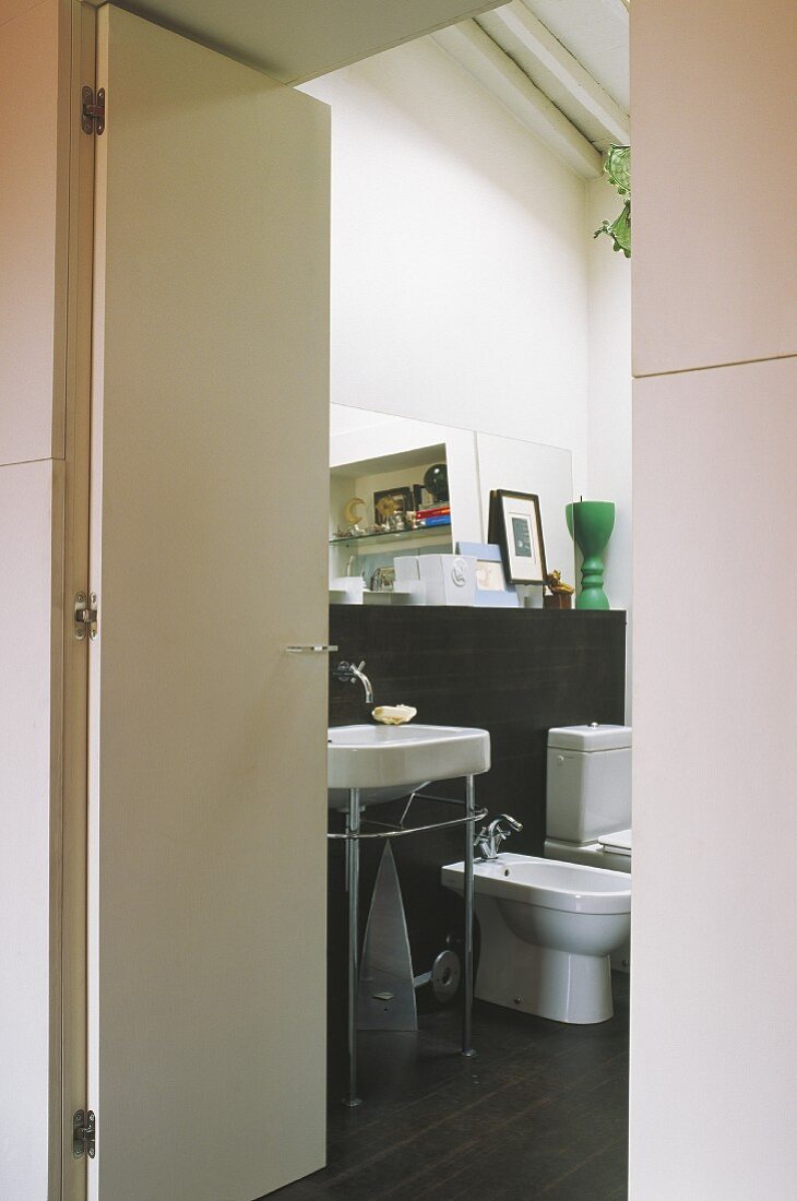 View of washstand and bathroom fittings through open door