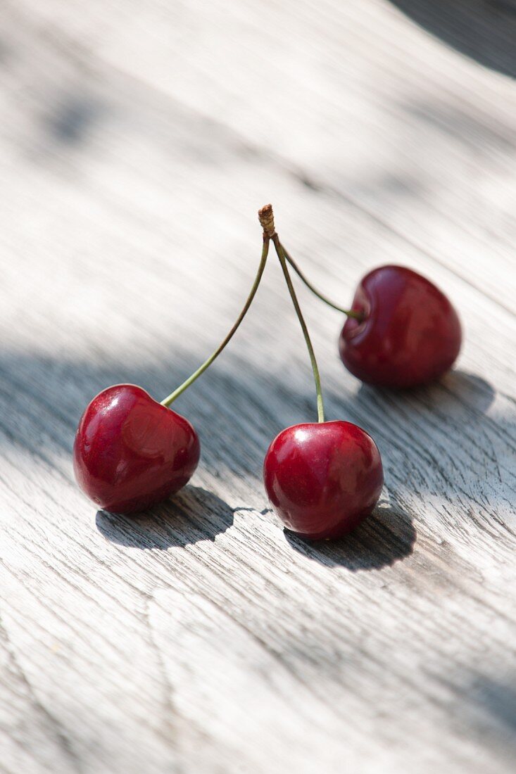 Three cherries on stalks
