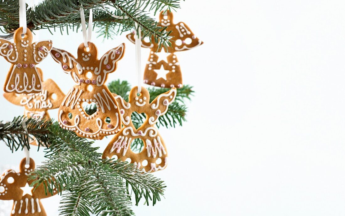 Gingerbread angels hanging on a Christmas tree