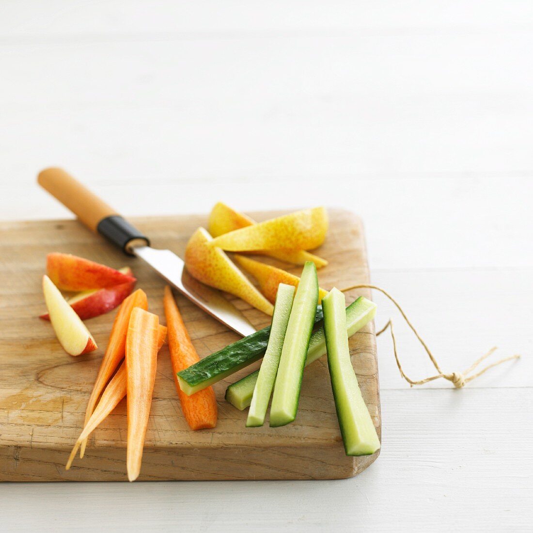 Sliced fruit and vegetables on a chopping board