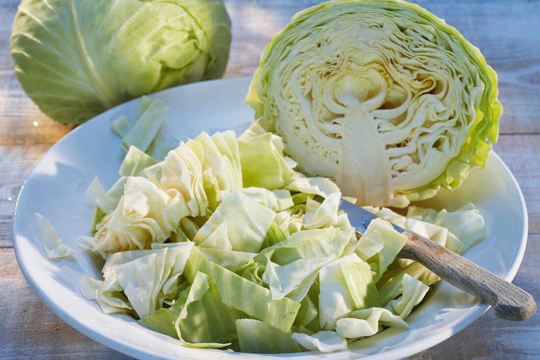 White cabbage, whole, halved and sliced