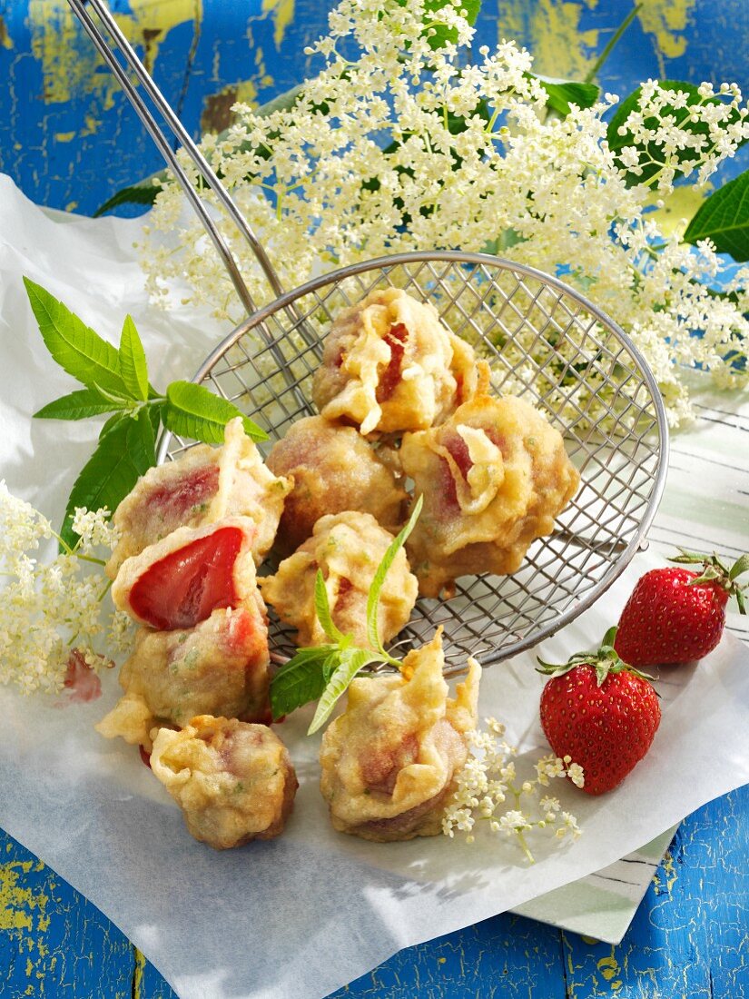 Strawberries in batter with elderflower syrup and lemon balm