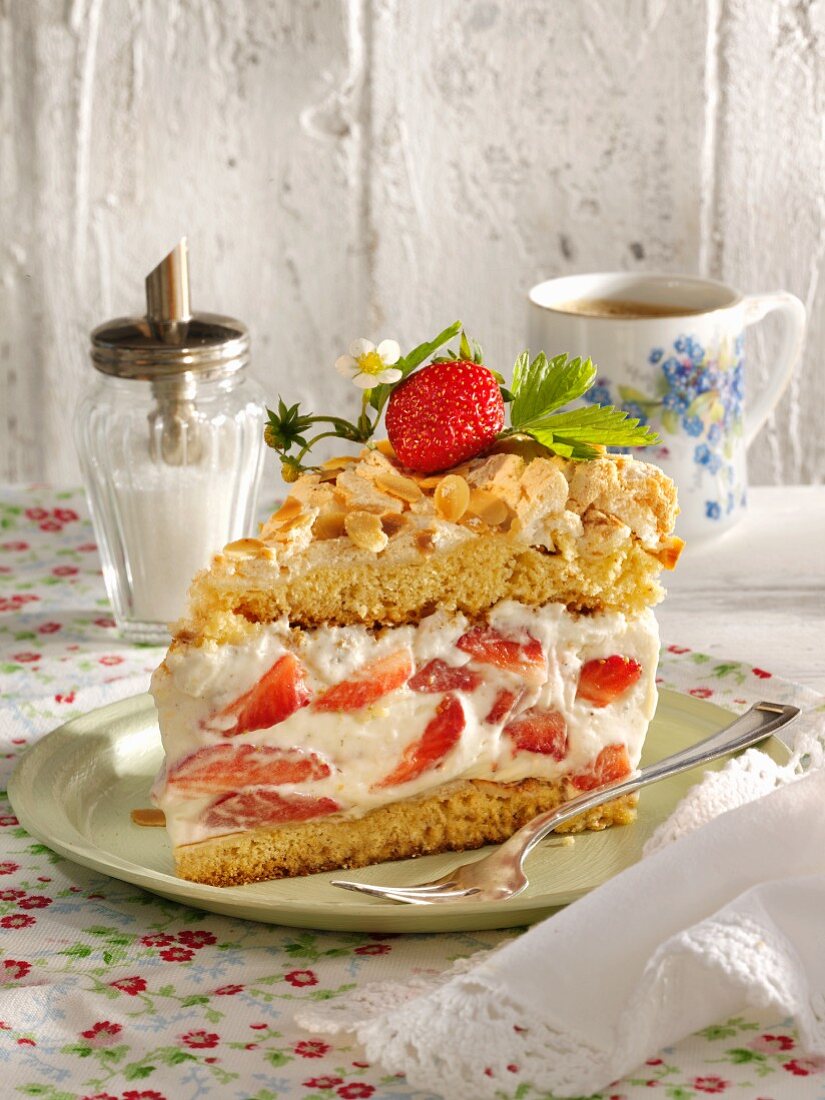 A slice of strawberry cream cake with meringue