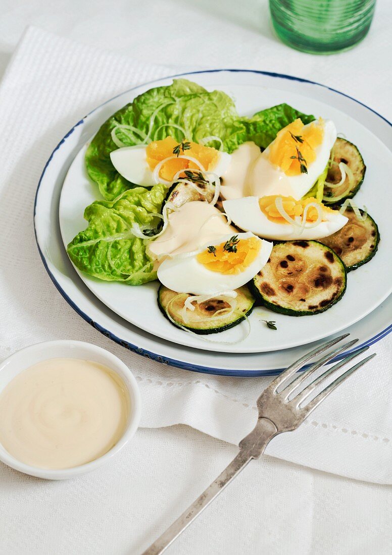 Salad with fried courgette sliced, eggs and mayonnaise