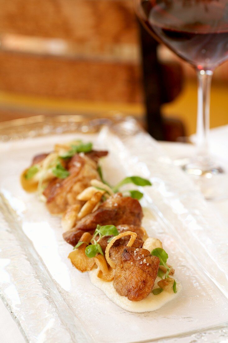 Pan Fried Chicken on a Narrow Platter; Glass of Wine