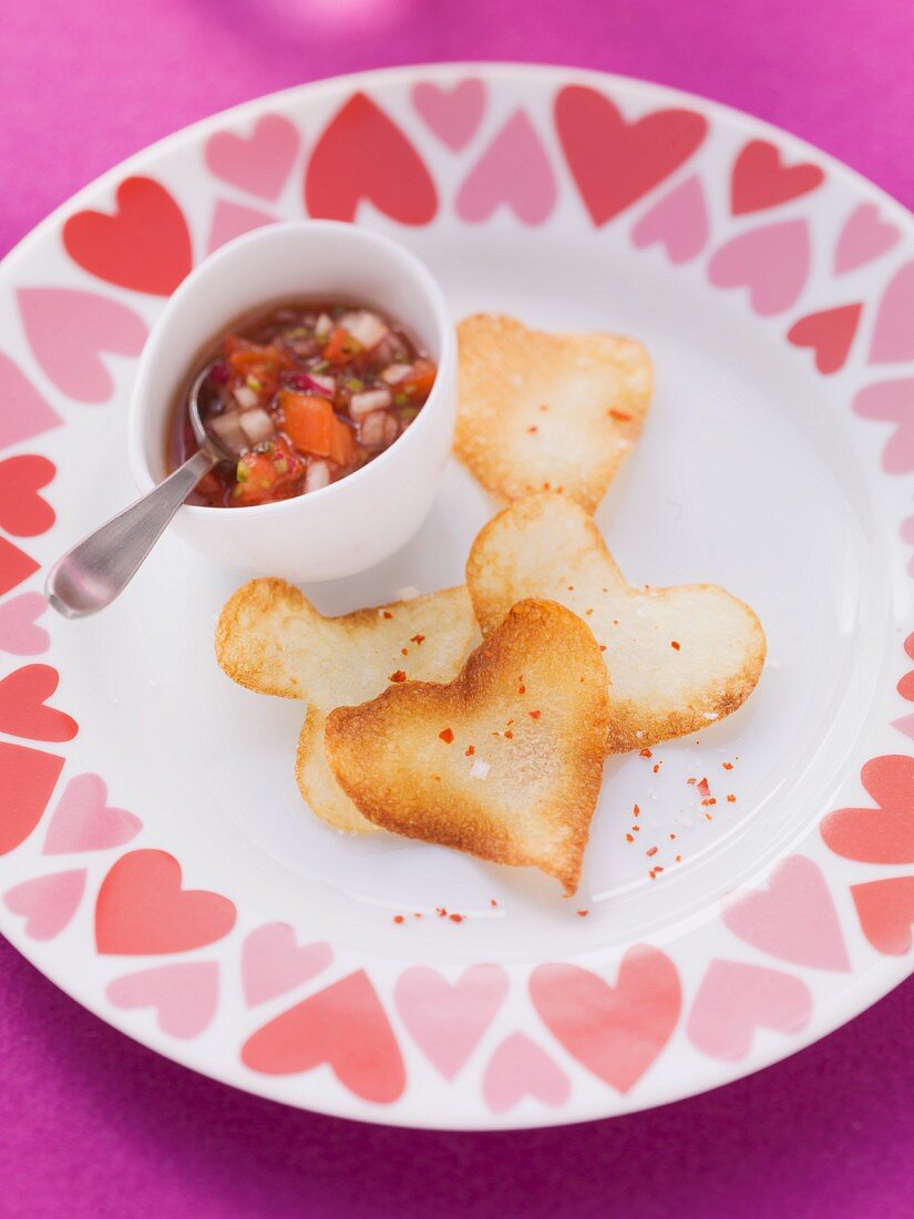 Heart-shaped crisps with a salsa dip