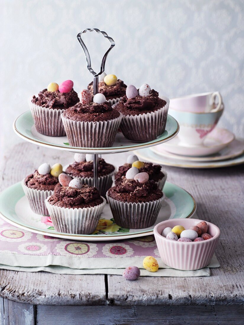 Chocolate cupcakes decorated with sugar eggs on a cake stand