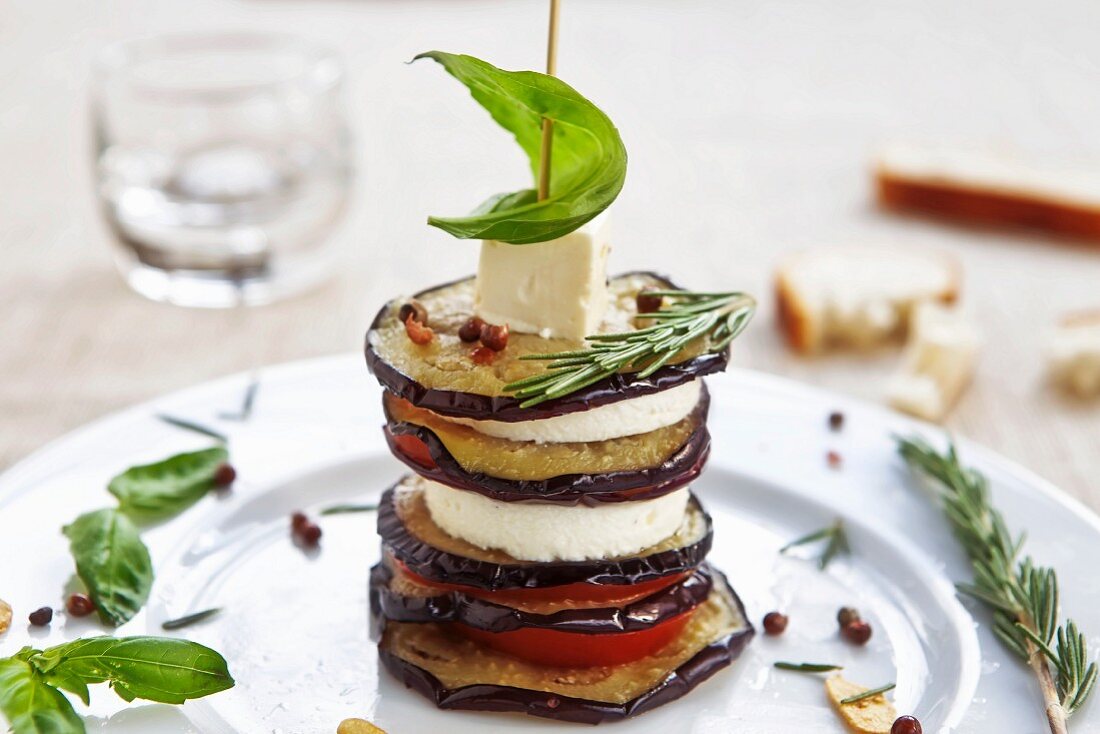 An aubergine and feta tower with basil and rosemary
