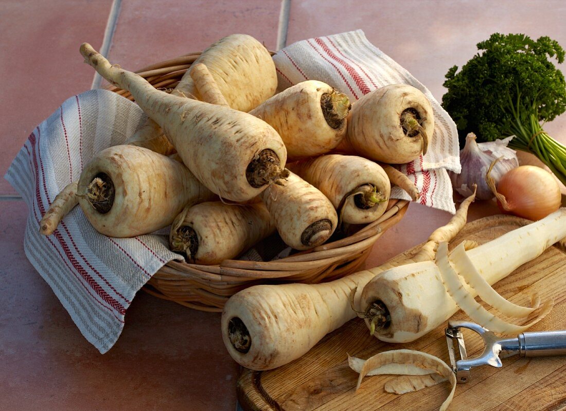 Unpeeled parsnips and one peeled parsnip