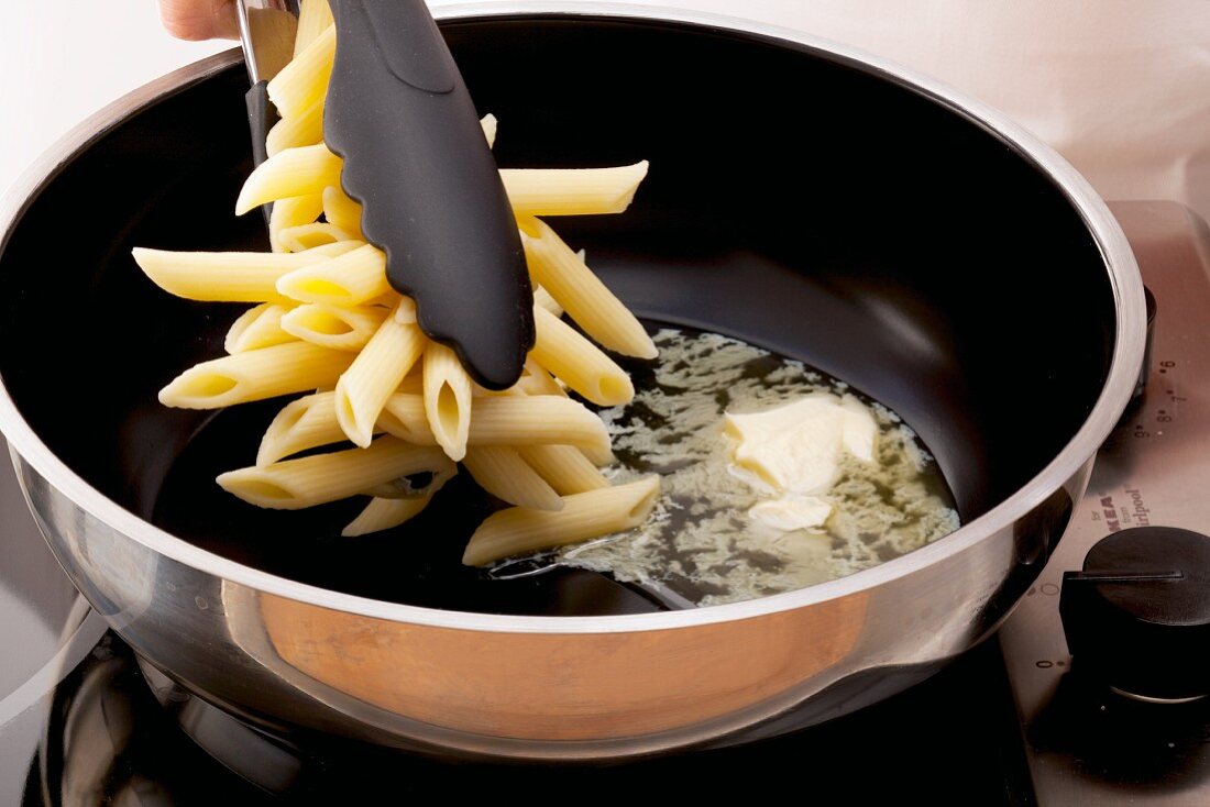 Pasta being fried in butter