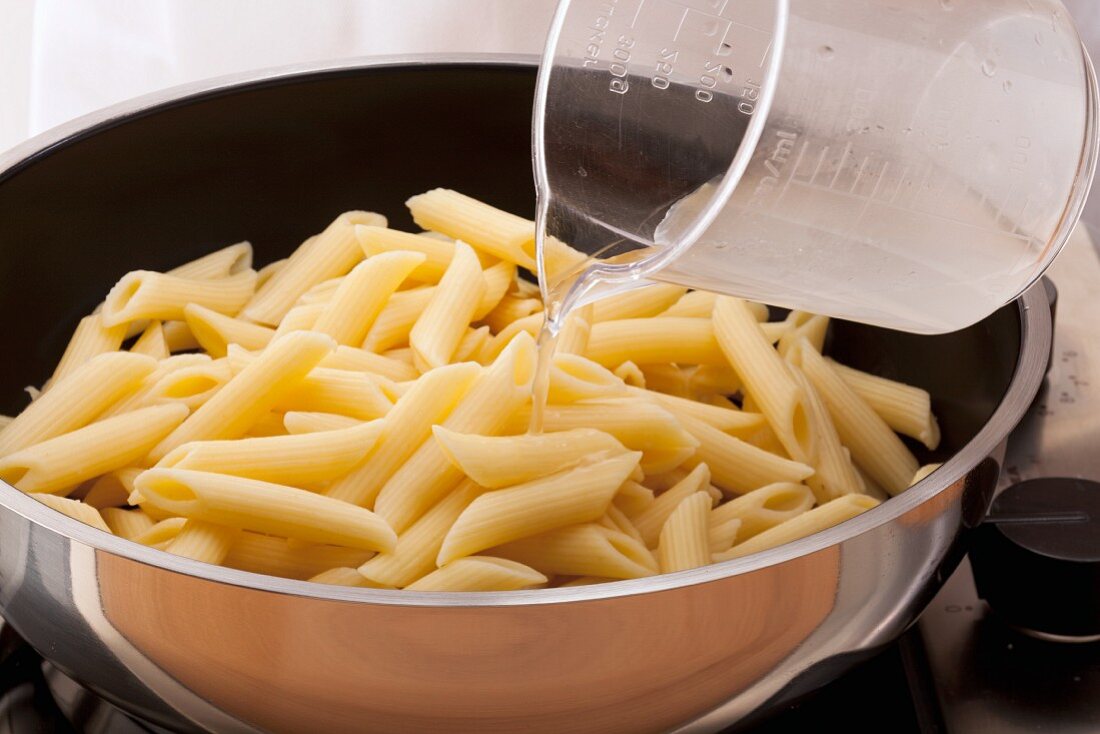 Pasta being heated in its cooking water