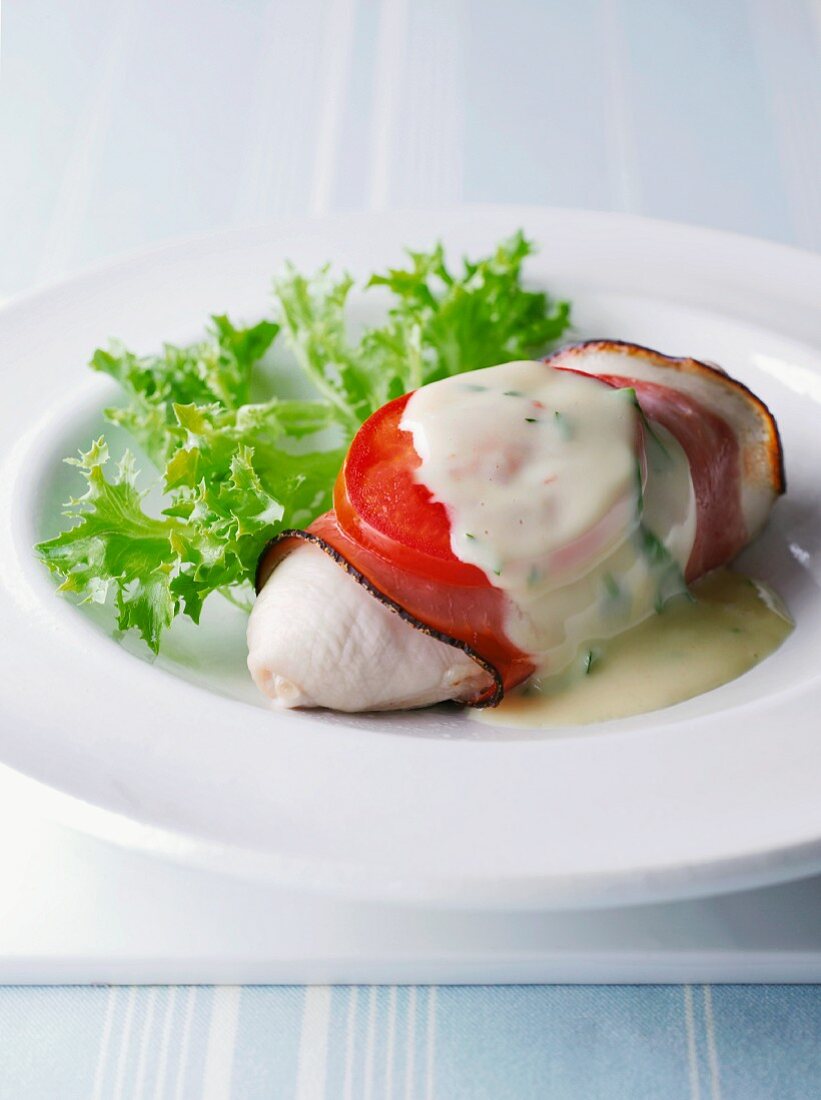 Chicken breast wrapped in ham with a tomato and herb sauce