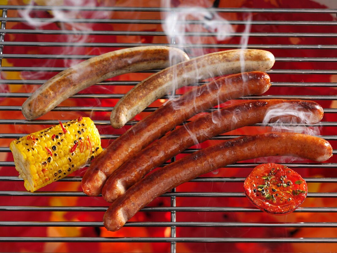 Smoking sausages on a grill