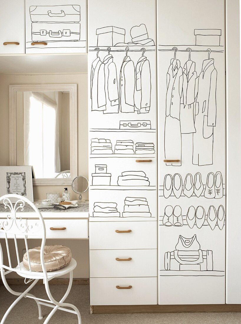 White, painted wardrobe next to a dressing table and chair