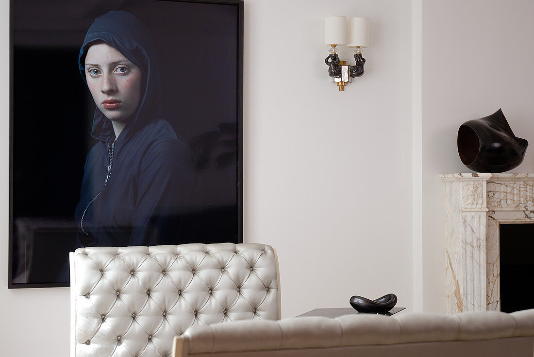 Modern portrait of woman behind quilted back of elegant recamiere in postmodern living room