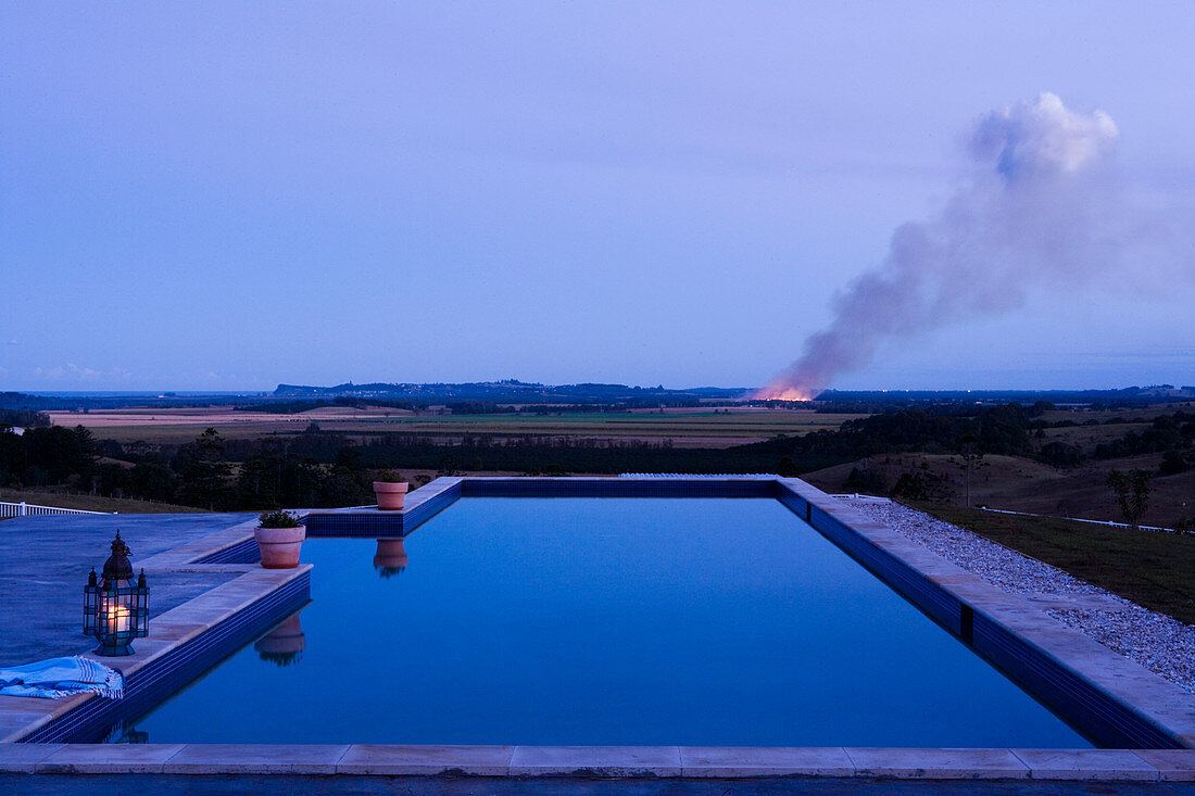 Modern roof terrace with a pool at dusk