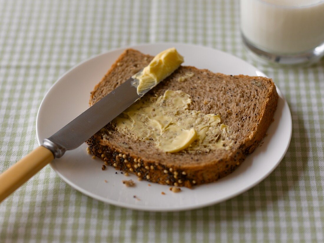 A slice of wholemeal bread spread with butter