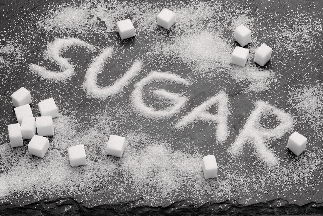 The word SUGAR written in sugar