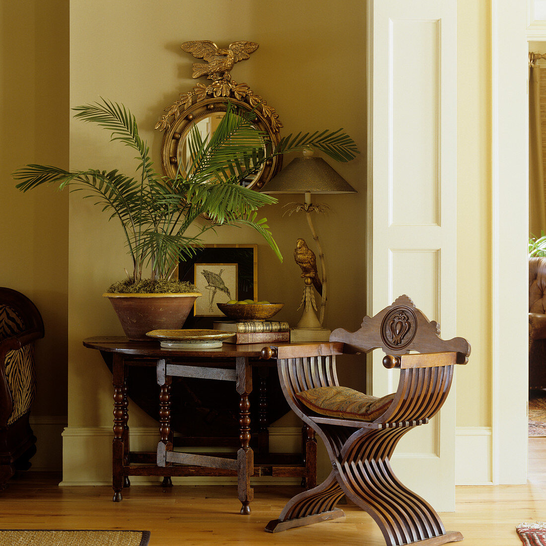 Detail of modern interior - antique wooden chair next to folding console table