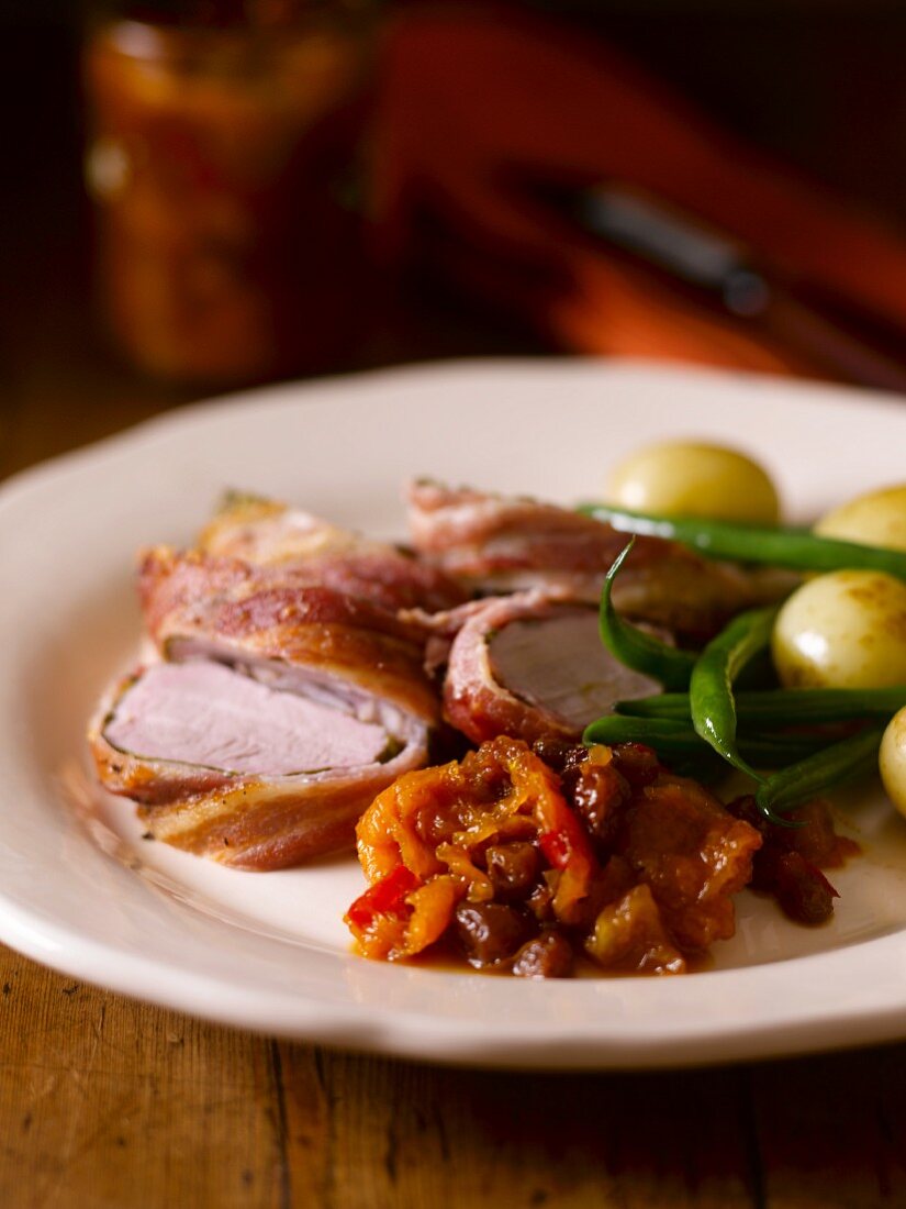 Pork fillet wrapped in bacon with a side of vegetables