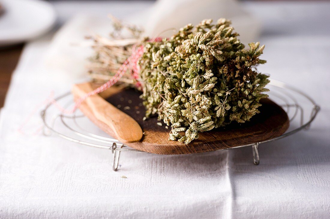 Dried herbs on a wooden board