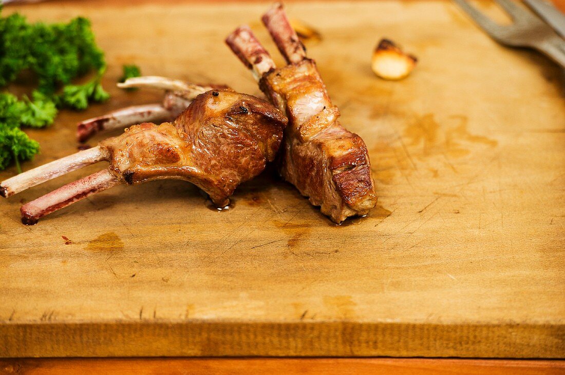 Fried lamb chops on a chopping board