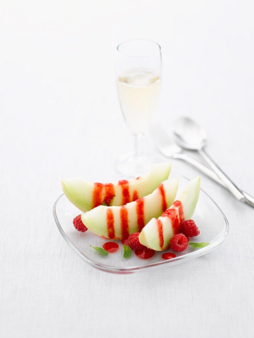 Honeydew melon with raspberries