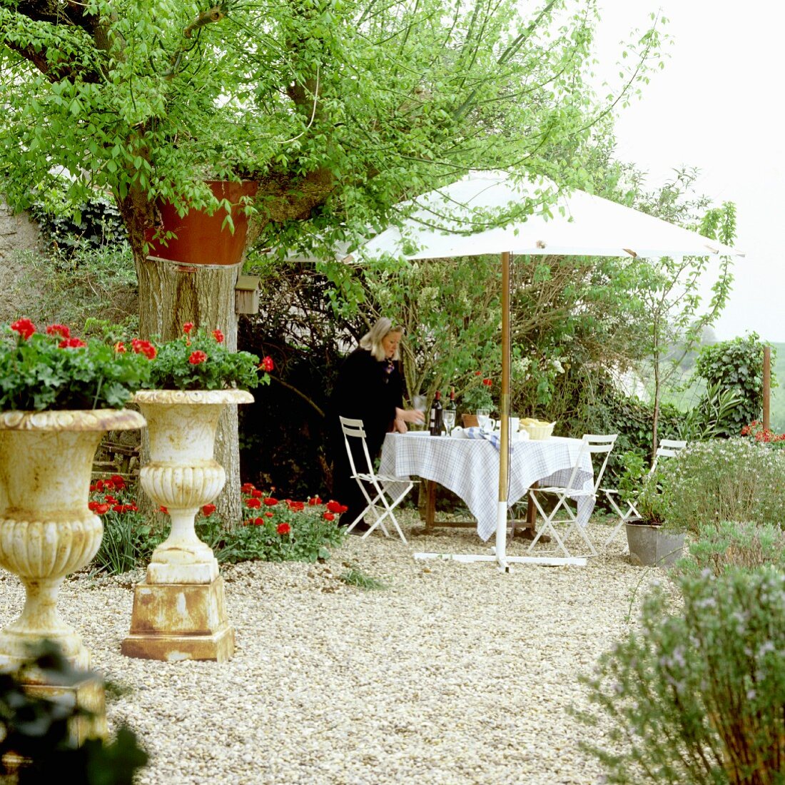 Afternoon tea in garden - set table below parasol