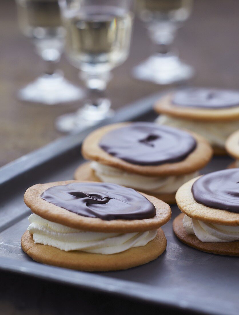 Sandwich biscuits filled with cream and topped with chocolate glaze