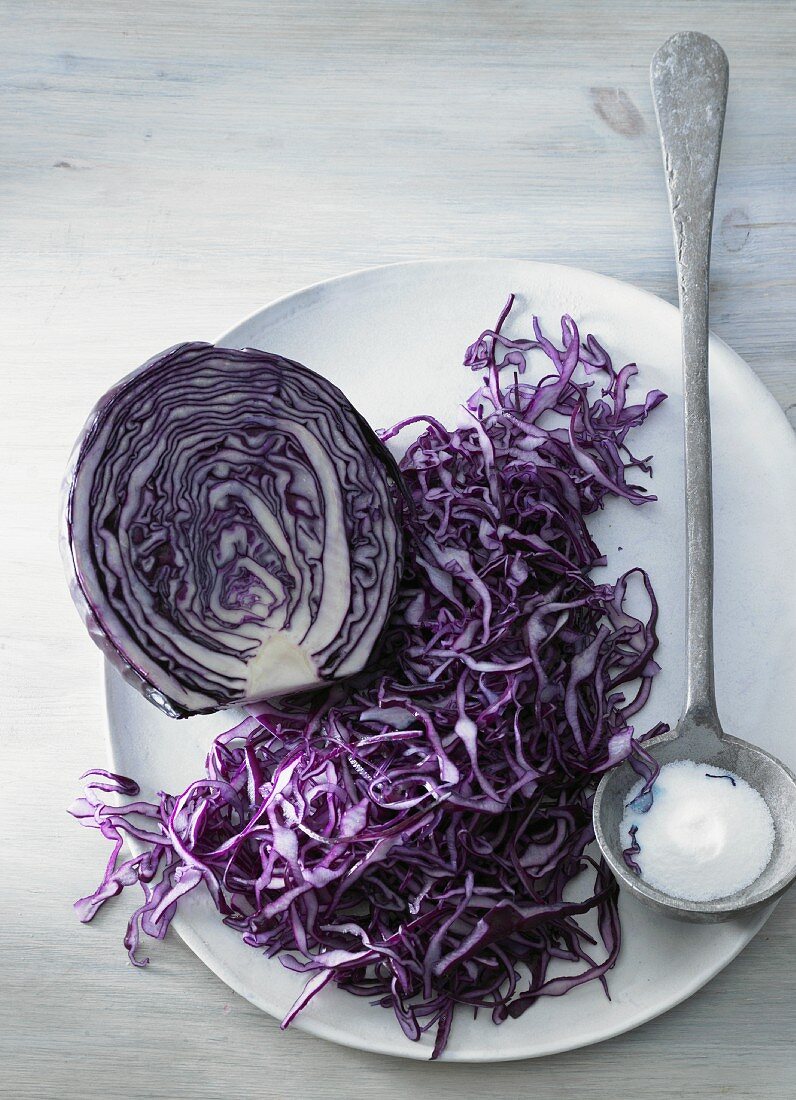 Red cabbage, halved and grated, and a spoonful of salt